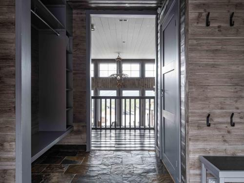a hallway with wooden walls and a glass door at Åre Valley Lodges - Kopparvillan in Åre