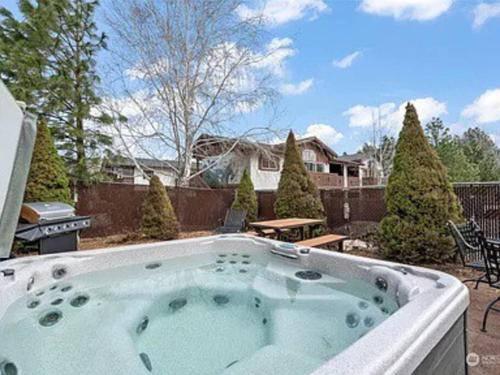 a hot tub in the backyard of a house at Cozy Bavarian Getaway in Leavenworth
