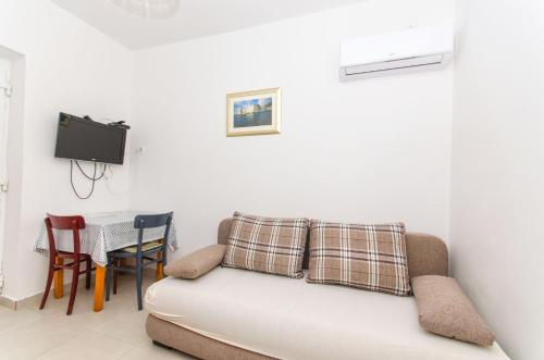 a living room with a couch and a table at Apartments Paolo in Okuklje