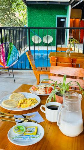 a wooden table with plates of food on it at Coffee House Minca in Minca