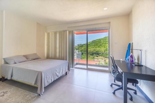 a bedroom with a bed and a desk and a window at Kahili Apartments in The Lime