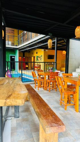 a group of wooden tables and chairs on a patio at Coffee House Minca in Minca