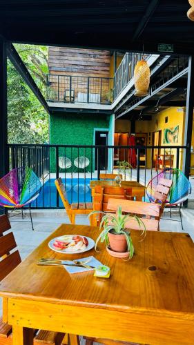 a wooden table with a plate of food on it at Coffee House Minca in Minca
