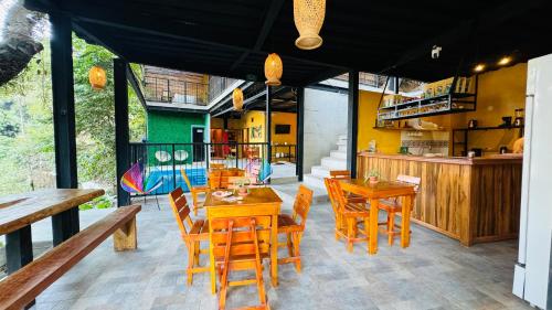a dining room with wooden tables and chairs at Coffee House Minca in Minca