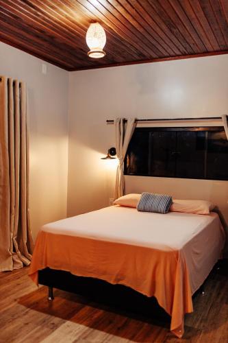a bedroom with a large bed in a room at Vila Ypáwa 150 m centro 30 m praia lago verde in Alter do Chao