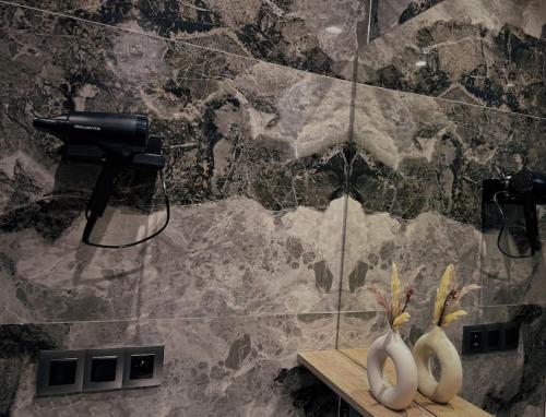 two vases sitting on a shelf in a bathroom at Cozy Appart central à terrasse in Casablanca
