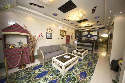 a living room with a couch and a fireplace at Hafez Hotel Apartments in Dubai