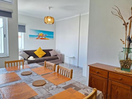 a living room with a table and a couch at AREIAS SOL in Albufeira