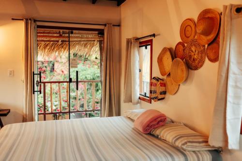 a bedroom with a bed and a window with a view at Vila Ypáwa 150 m centro 30 m praia lago verde in Alter do Chao