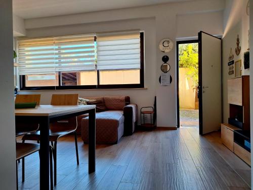 a living room with a table and a couch at Itaca in Lido di Fermo