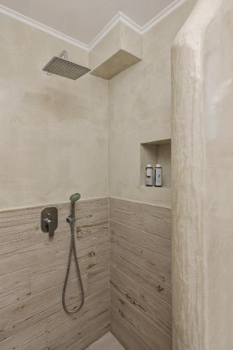 a bathroom with a shower with a shower head at Scarabeo Suites & Villas Parga in Parga