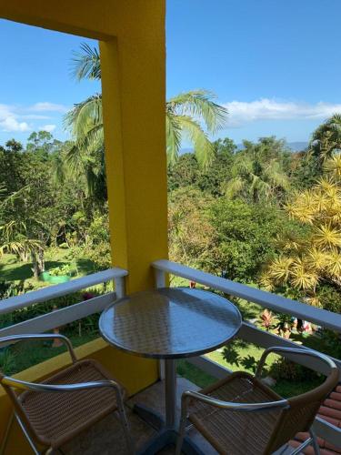 a table and chairs on a balcony with a view at Hotel Pousada 7 Mares in Itapema