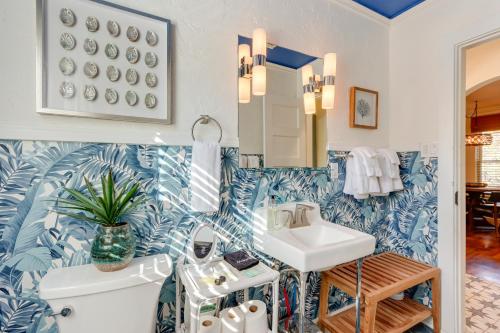 a bathroom with blue and white wallpaper and a sink at Chic Joplin Cottage with Patio Less Than 3 Mi to Town! in Joplin