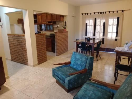 a living room with a kitchen and a dining room at Casa con excelente ubicacion in Posadas