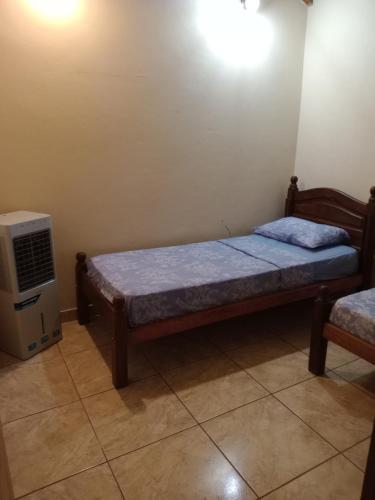 a small bedroom with a bed and a heater at Casa con excelente ubicacion in Posadas