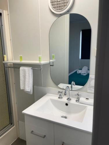 a bathroom with a white sink and a mirror at Fishing Haven Holiday Park in Palmers Island