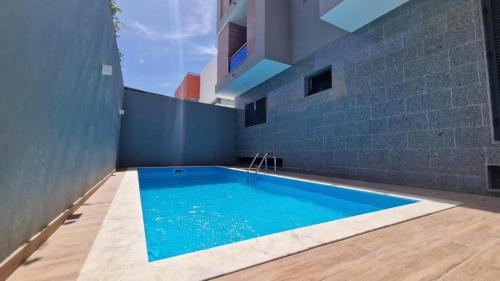 a swimming pool in the middle of a house at Aparthouse EdHel T2 in Praia