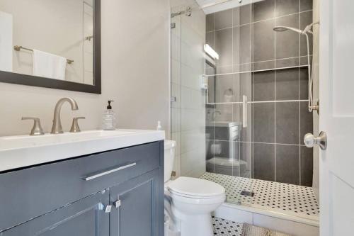 a bathroom with a toilet and a sink and a shower at Stylish guest house near colleges in Claremont