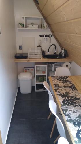 a kitchen with a table and chairs and a sink at Zaciszny Zakątek Zawoja in Zawoja