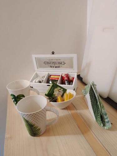 a table with two cups and a box of food at Zaciszny Zakątek Zawoja in Zawoja