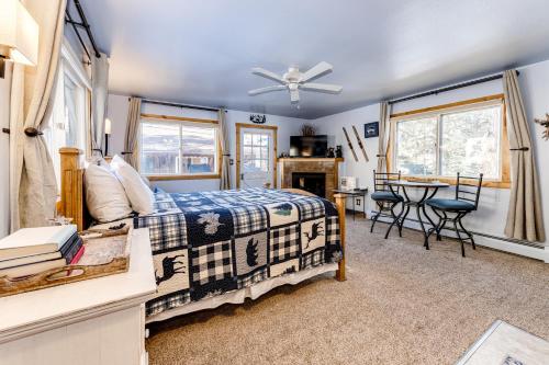 a bedroom with a bed and a table and chairs at Mountain Love Views in Estes Park