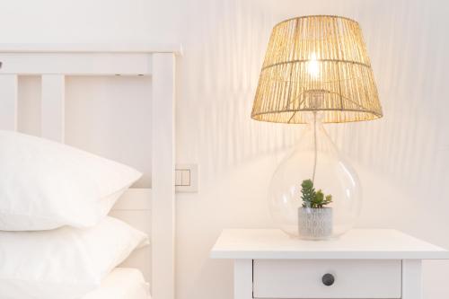 a lamp on a table next to a bed at Dream Suite in Como in Como