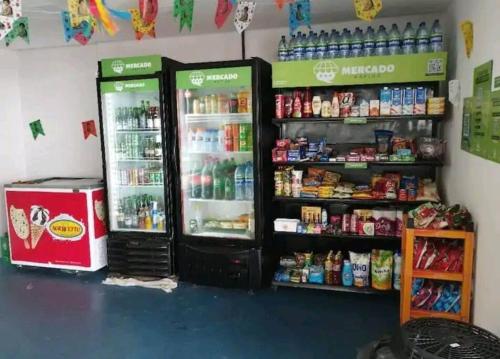 two refrigerators are in a store with drinks at Flat Mobiliado em excelente localização in Campina Grande