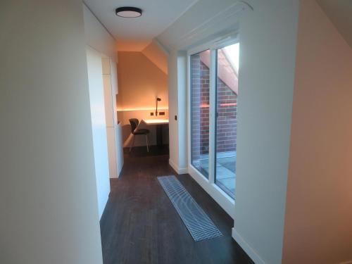 an empty hallway with a window and a desk at Hotelapartment Meerlust in Cuxhaven