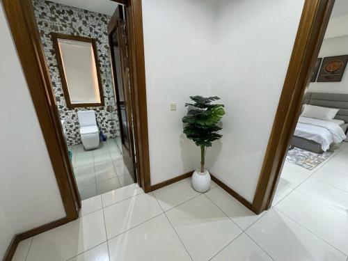 a room with a mirror and a vase with a plant at Zara 2 in Lekki