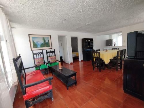 a living room with a table and chairs at Torre del Sol in Villavicencio