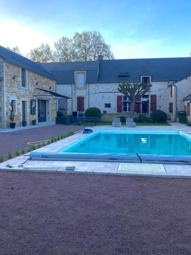 une grande piscine devant une maison dans l'établissement Maison familiale avec piscine, à Saint-Amand-Montrond