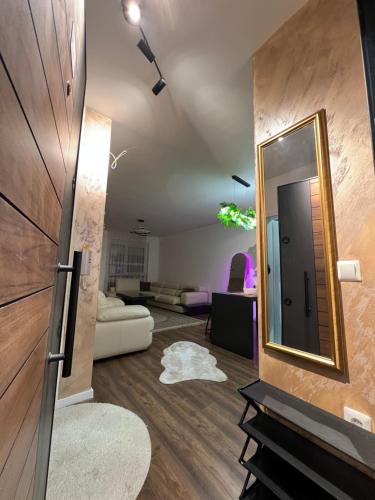 a living room with a mirror on the wall at Lysa Apartment in Kosovo Polje