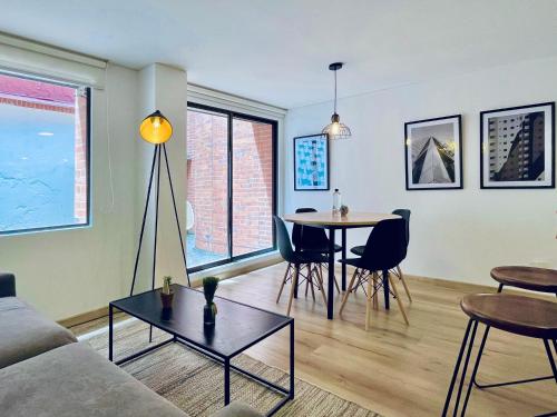 a living room with a couch and a table at Palace by Wynwood House in Bogotá