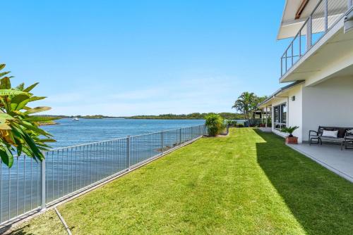 a balcony of a house with a view of the water at Jeffery River Retreat - Best Sunsets in Yamba in Yamba