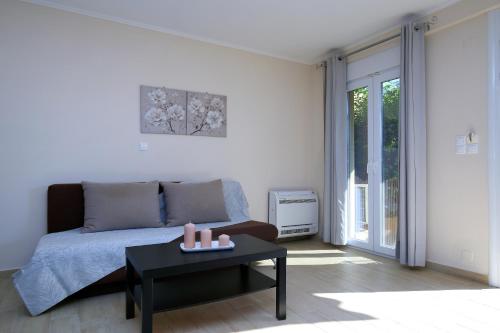 a bedroom with a bed and a table with candles at Neapolis Apartment in Lefkada