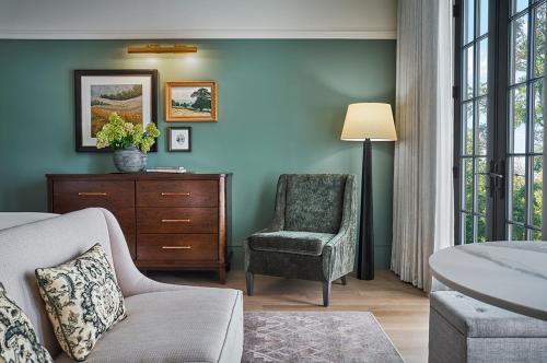 a bedroom with a couch and a chair and a window at Pendry Natirar in Peapack
