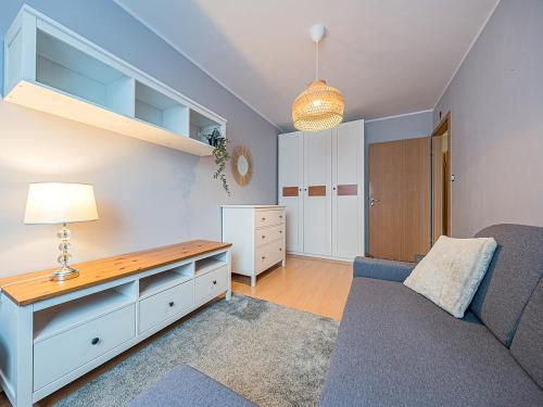 a living room with a couch and a table at CITYSTAY Reja Apartament z parkingiem in Gdynia