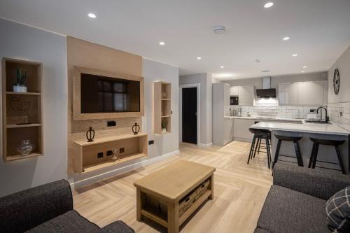 a kitchen and living room with a table and a couch at The Charleston in Blackpool