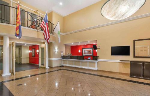 a lobby with two flags in a building at Extended Stay America Suites - Phoenix - Midtown in Phoenix