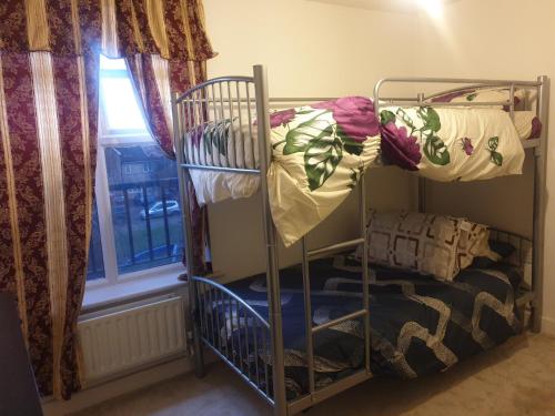 a couple of bunk beds in a room with a window at Residential property in Edmonton