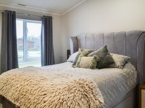 a bed with a furry blanket on it with a window at Lake View No, 65 in Routh