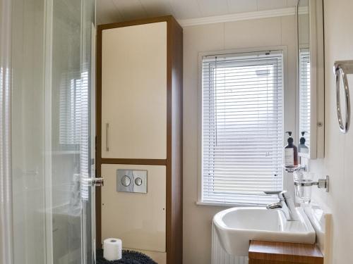 a bathroom with a sink and a shower at Lake View No, 65 in Routh