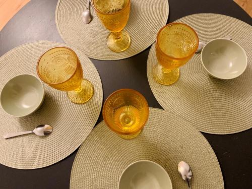 a group of yellow cups and plates and bowls on a table at Finsbury Park London Apartment - 10 minutes to central London in London