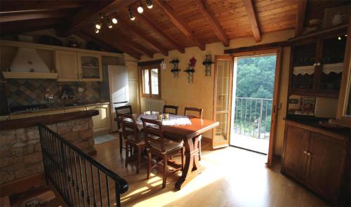 a dining room with a table and chairs and a window at La Casetta Vacanze in Molini di Triora