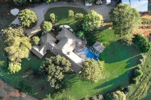 an aerial view of a house with a garden at Beautiful Farmhouse w/ pool on 6 acres ranch in Aubrey