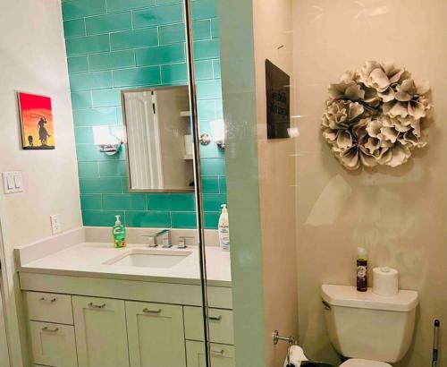 a bathroom with a sink and a toilet and a mirror at Beautiful Farmhouse w/ pool on 6 acres ranch in Aubrey