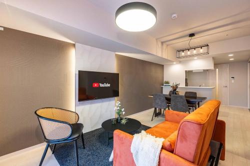 a living room with a couch and a table at FDS AURA in Osaka