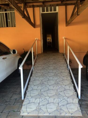 a car parked in front of a building with a tunnel at Casa da Ponte Hotel in Goiás