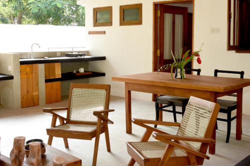 a living room with a table and chairs and a sink at Villa Polhena in Matara