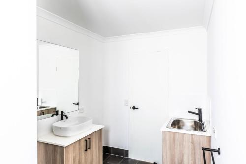 a bathroom with a sink and a mirror at 17 Cooyou Close in Exmouth